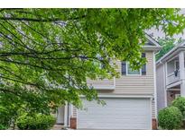 Charming home featuring tan siding, a white garage door, and well-maintained landscaping at 541 Shadow Valley Ct, Lithonia, GA 30058