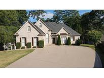 Charming brick home with a well-maintained lawn and mature trees at 255 Carriage Station Dr, Lawrenceville, GA 30046