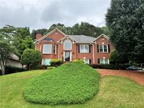 Beautiful brick home with manicured lawn and mature trees at 208 Regency Ct, Acworth, GA 30102