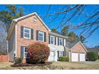 Charming two-story brick home with well-manicured front yard and attached two car garage at 3090 Perch Sw Ln, Marietta, GA 30008
