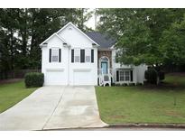 Charming two-story home with a well-manicured lawn and an inviting facade with a two-car garage at 262 Devynwood Ln, Dallas, GA 30157