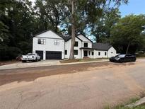 Stunning two-story home with black trim, a 2-car garage, and long driveway at 2764 Midway Rd, Decatur, GA 30030