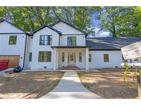 Charming two-story white home featuring black-trimmed windows and a covered front porch at 2764 Midway Rd, Decatur, GA 30030