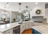 Bright, open kitchen with granite countertops, a center island, and stainless steel appliances at 5173 Brendlynn Dr, Suwanee, GA 30024