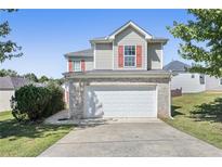 Two-story home featuring a two-car garage and red shutters for added curb appeal at 139 Palmetto St, Locust Grove, GA 30248