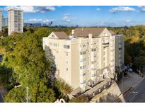 Stunning seven-story condo building with beautiful tan exterior, decorative windows, and manicured landscaping near the city at 2499 Peachtree Rd # 506, Atlanta, GA 30305