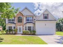 Two-story home featuring a stone facade and manicured lawn at 4938 Wewatta Sw St, Atlanta, GA 30331