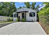 Charming home with a well-manicured lawn, featuring a driveway and a welcoming entrance at 1268 Ladd Sw St, Atlanta, GA 30310