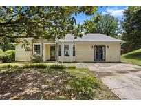Charming home featuring a stone accent, light yellow siding, and a unique turret-style window at 3357 Saddleton Way, Douglasville, GA 30134