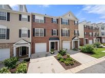 Townhouse exteriors boast brick and siding, with attached garages and manicured landscaping at 3542 Chattahoochee Summit Se Ln, Atlanta, GA 30339