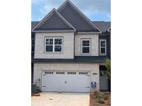 Charming two-story townhome with a one car garage, gray brick, and gray trim at 3104 Marbella Cir # 2, Kennesaw, GA 30152