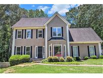 Charming two-story home with a well-manicured lawn, lush landscaping, and a classic façade at 3774 Seasons Nw Dr, Acworth, GA 30101