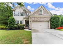 Charming two-story home with a well-manicured lawn and a two-car garage at 6160 Overleaf Ter, Cumming, GA 30040
