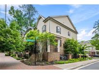 Charming two-story home with brick and siding exterior, lush landscaping, and welcoming front entrance at 148 Canton St, Alpharetta, GA 30009