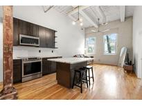 Modern kitchen featuring stainless appliances, a center island with bar stools, and abundant natural light at 210 Walker Sw St # 3, Atlanta, GA 30313