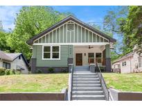 Charming craftsman-style home featuring a large front porch, green siding, and a well-maintained front yard at 905 Gaston Sw St, Atlanta, GA 30310