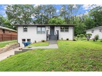 Charming one-story home featuring a well-maintained front yard and inviting entrance at 569 Oakside Sw Dr, Atlanta, GA 30331