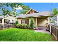 Charming single story home with a well manicured lawn, quaint front porch, and picket fence at 176 Ormond Se St, Atlanta, GA 30315