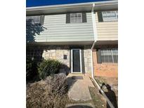 Two story townhome with stone accents, and neutral colored siding at 4701 Flat Shoals Rd # 48B, Union City, GA 30291
