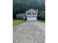 Charming two-story home featuring a two-car garage and a well-maintained front yard at 5388 Robertson Path, Lithonia, GA 30038
