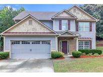 Charming two-story home with a well-manicured front yard and two-car garage, perfect for Gathering living at 1099 Sandy Bank Ct, Auburn, GA 30011