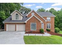 Charming brick two-story home with a two-car garage and well-manicured lawn at 1784 Brookstone Nw Ct, Acworth, GA 30101