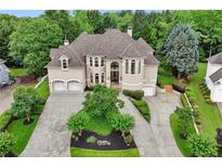 Stunning two-story home featuring a three-car garage, manicured landscaping, and a circular driveway at 2503 Regency Lake Dr, Marietta, GA 30062