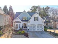 Charming two-story home with a well-maintained front yard, two-car garage and lovely landscaping at 3355 Olivia Ct, Cumming, GA 30041