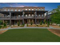 Attractive brick townhomes feature private terraces overlooking a manicured lawn at 6370 Cortland Walk, Alpharetta, GA 30005