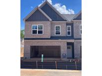 New construction townhome featuring brick exterior, attached garage, and modern architectural details at 3108 Marbella Cir # 4, Kennesaw, GA 30152