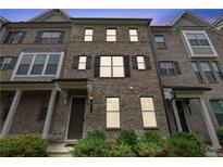 Charming brick townhome featuring black shutters and a welcoming front entrance at 2182 Talmai Dr, Snellville, GA 30078