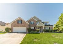 Charming brick two-story home with a well-manicured lawn and attached two-car garage at 1031 High Tide Ct, Loganville, GA 30052