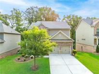 Inviting two-story home with a well-manicured lawn and a two-car garage, perfect for a growing Gathering at 1838 Lakeview Bend Way, Buford, GA 30519