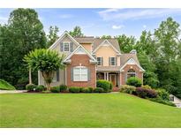 Charming two-story home with brick and siding accents and a well-manicured lawn at 223 Oak Grove Dr, Dallas, GA 30157