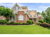 Charming two-story brick home with well-manicured lawn and mature landscaping at 223 Oak Grove Dr, Dallas, GA 30157