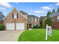 Charming brick home with a well-manicured lawn and a two-car garage at 3032 Montclair Se Cir, Smyrna, GA 30080