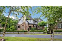 Beautiful exterior elevation of a two-story home with brick and stone accents and professionally landscaped yard at 4224 Dogwood Bend Park, Duluth, GA 30096