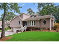 Charming two-story home with a well-maintained lawn, manicured landscaping, and inviting entrance at 657 Polk Nw St, Marietta, GA 30064