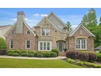 Stunning two-story brick and stone home with manicured landscaping at 702 Crescent Cir, Canton, GA 30115