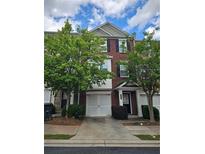 Two story brick townhome with attached garage and beautiful mature trees at 2137 Meadow Peak Rd, Duluth, GA 30097