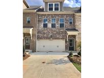 Charming brick townhome with a two-car garage and inviting curb appeal at 3677 Hidden Valley Cir, Lawrenceville, GA 30044