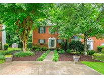 Charming two-story brick home with lush landscaping and inviting front entrance at 3040 Majestic Park Ct, Duluth, GA 30096