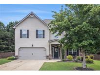 Charming two-story home features a manicured front lawn, attached garage, and inviting curb appeal at 5925 Whitney Ct, Cumming, GA 30041