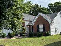 Charming single-Gathering home featuring brick and siding, complemented by a well-maintained lawn and mature trees at 3690 Crescent Walk Ln, Suwanee, GA 30024