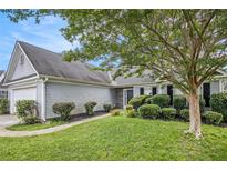 Charming one-story home featuring a well-manicured lawn, neatly trimmed shrubs, and gray siding at 104 Terrapin Ct, Carrollton, GA 30116