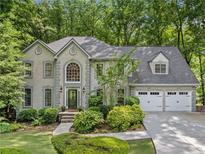 Charming two-story home with a well-manicured lawn, mature trees and a two car garage at 4402 Windsor Oaks Chase, Marietta, GA 30066