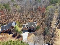 Beautiful aerial view of a two-story brick home with an attached two-car garage and mature landscaping at 465 Woodbrook Ways, Lawrenceville, GA 30043