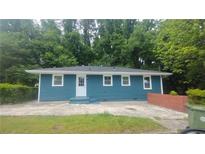 Exterior shot of home with blue siding and a well-maintained yard, exuding curb appeal and a welcoming ambiance at 81 Burbank Nw Dr, Atlanta, GA 30314