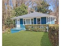 Charming blue home featuring a well-maintained lawn and a welcoming front porch at 81 Burbank Nw Dr, Atlanta, GA 30314