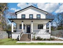 Charming two-story home with a covered porch and black trim accents, perfect for curb appeal at 912 Ira Sw St, Atlanta, GA 30310